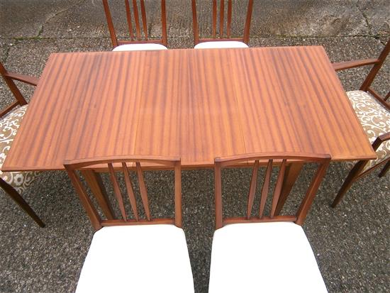 A Gordon Russell teak extending dining table and six chairs (4+2 carvers)